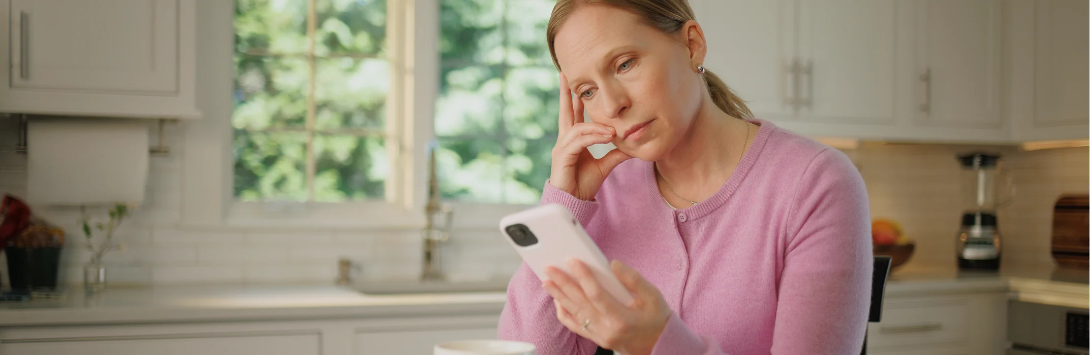 Woman on her phone researching chronic HypoPARAthyroidism